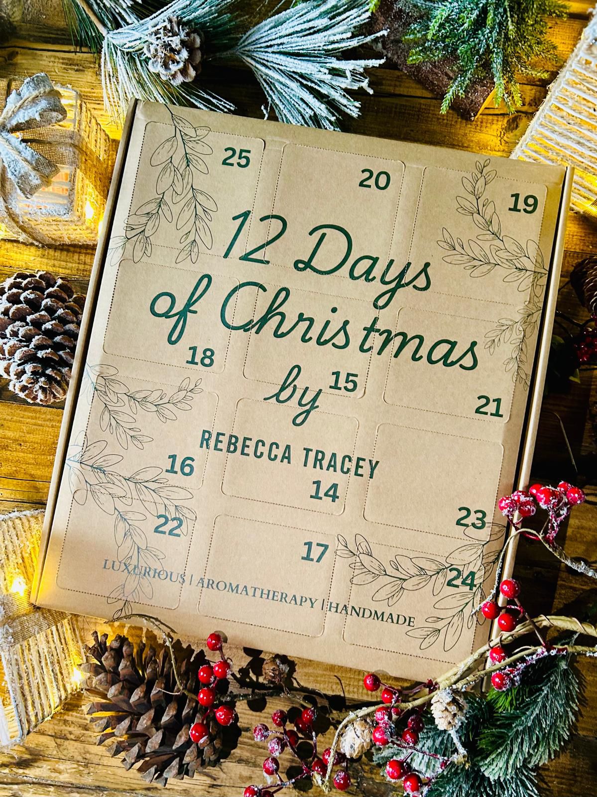 Advent calendar titled '12 Days of Christmas' by Rebecca Tracey on a wooden surface with Christmas decorations.