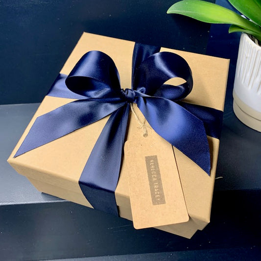 Gift wrapped box - kraft box wrapped with navy blue ribbon