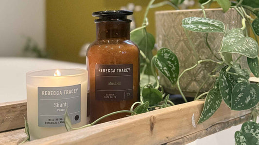 bath candle and salt next to a plant 
