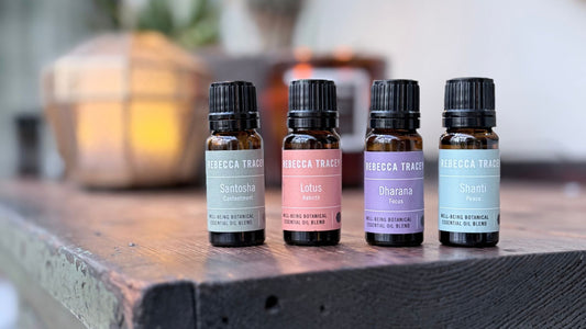 a selection of essential oils lined up on a side unit.