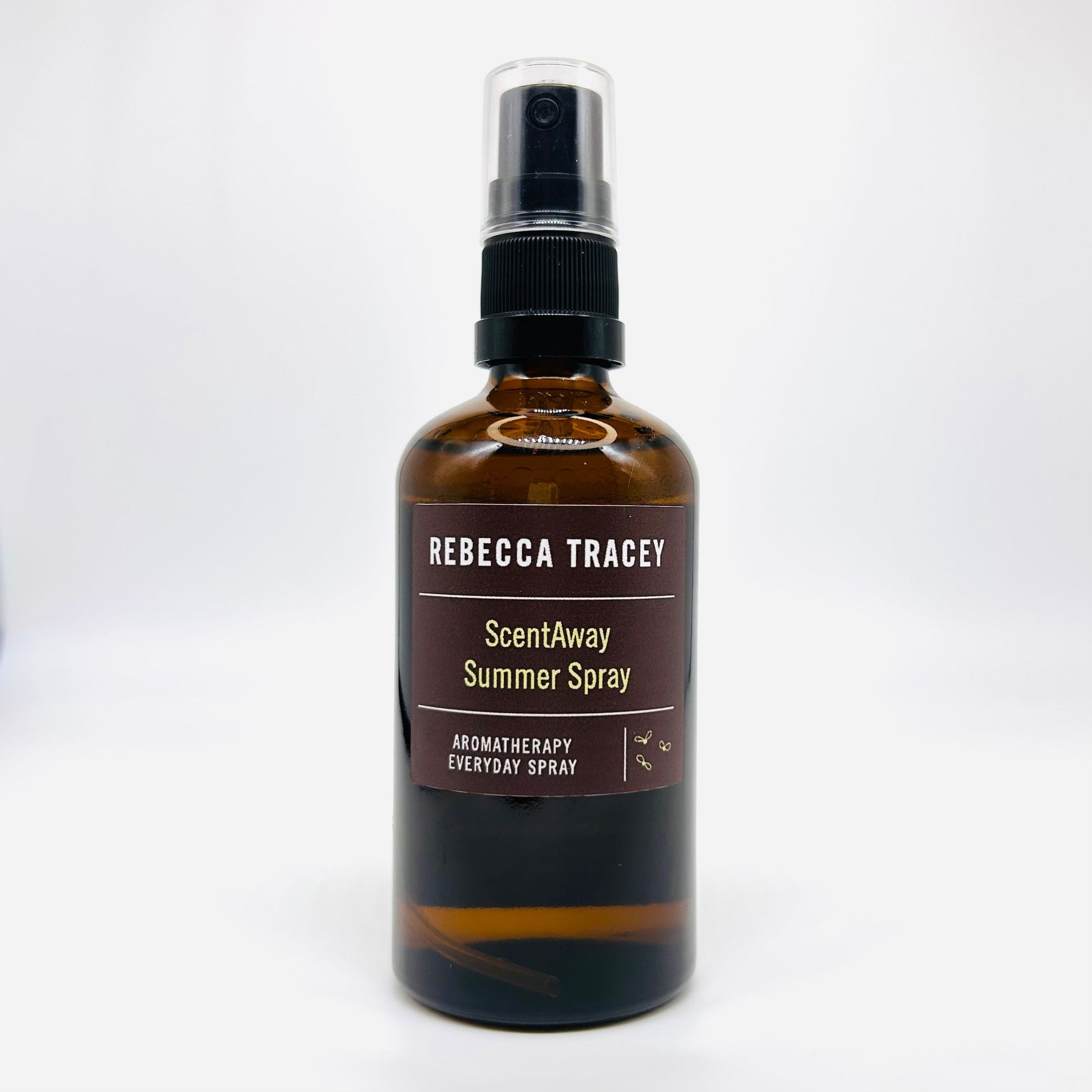 A bottle of Rebecca Tracey ScentAway Summer Spray, an aromatherapy everyday spray, in an amber glass bottle with a black spray pump and a brown label.
