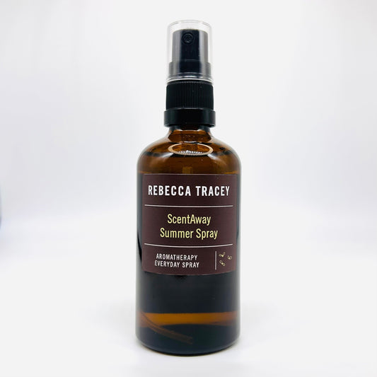 A bottle of Rebecca Tracey ScentAway Summer Spray, an aromatherapy everyday spray, in an amber glass bottle with a black spray pump and a brown label.